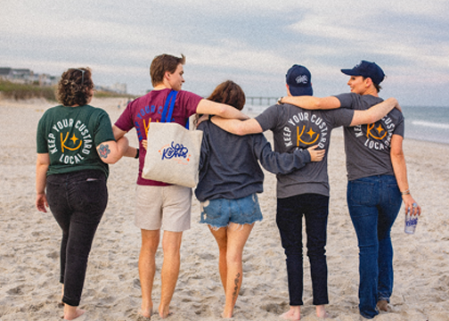 a group of people wearing matching screen printed Kohls Custard Tee Shirts